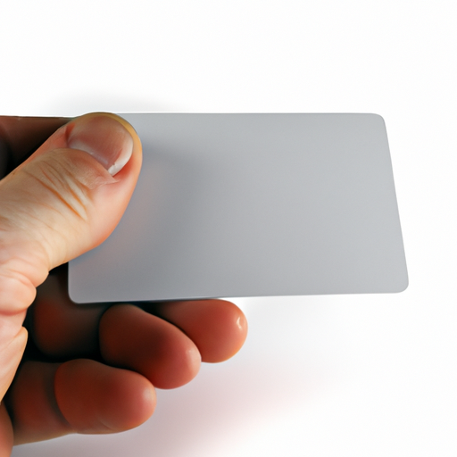 A close up of a hand holding a business card