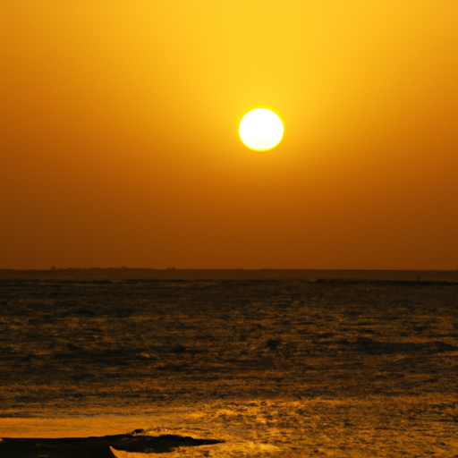 A yellow sun setting behind a tropical beach